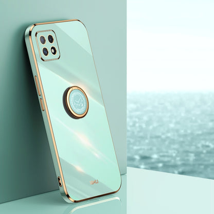 Mint green TPU phone case with gold ring holder and camera cutouts