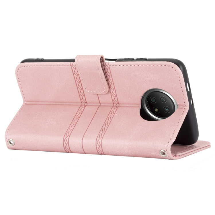 Pink horizontal flip wallet case with camera cutout, strap tab, and embossed stripes