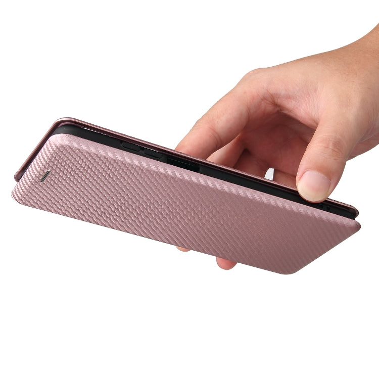 Hand holding pink magnetic flip phone case with carbon fiber texture cover