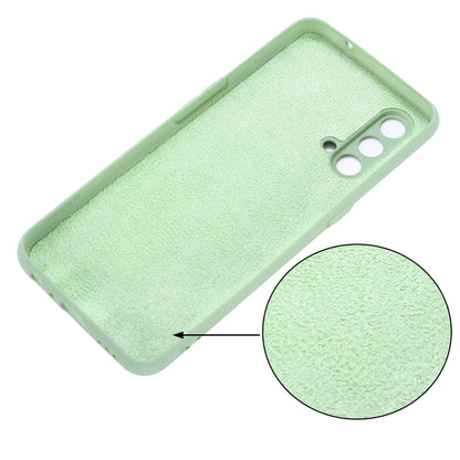 Green silicone case close-up showing grippy texture and camera opening.