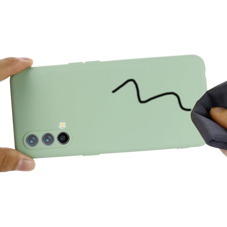 Green silicone phone case shown in use, with protective bumper fit.