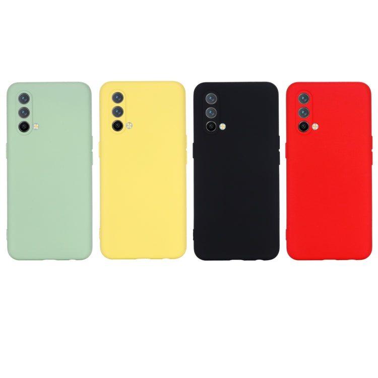 Liquid silicone phone cases in green, yellow, black, and red with camera cutouts.