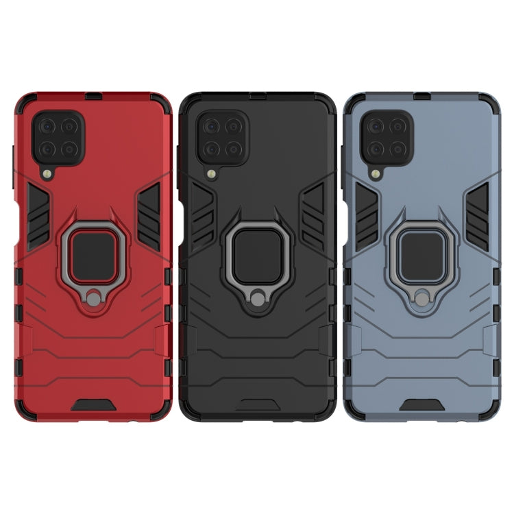 Shockproof phone cases in red, black, and light blue with magnetic ring holders
