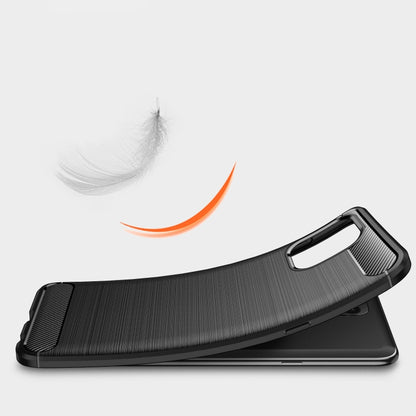 Black brushed carbon-fiber TPU phone case side profile with textured grip and bumper.