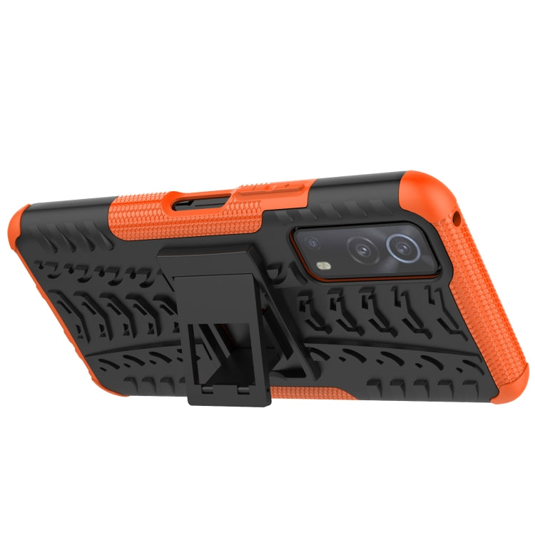 Black and orange textured rugged phone case with camera cutout and holder detail