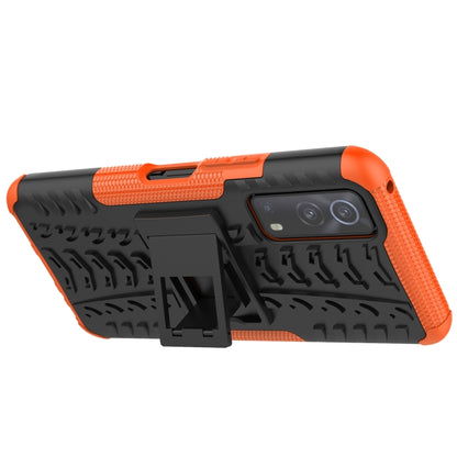 Black and orange textured rugged phone case with camera cutout and holder detail