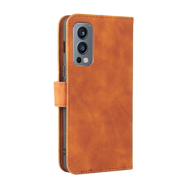 Brown PU leather flip phone wallet case with camera cutout and side hand strap.