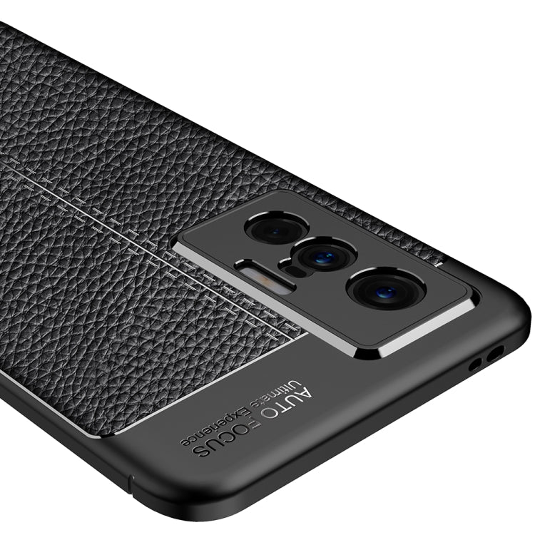 Black litchi-texture TPU case close-up of triple-camera opening and buttons