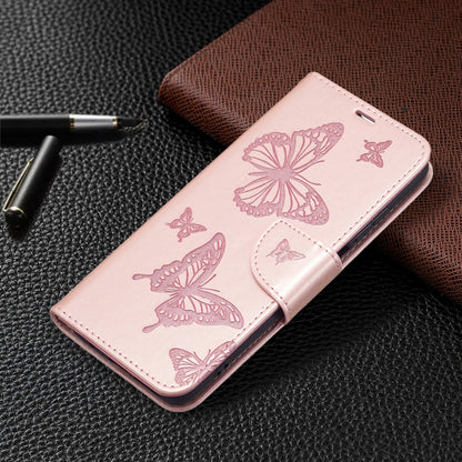 Pink leather phone case with butterfly embossing; slim flip wallet design.