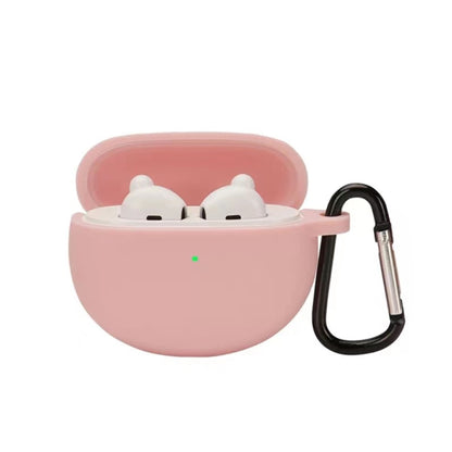 Pink silicone earbud case with hook, holding two white earbuds in a lid-open shell