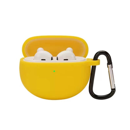 Yellow silicone earbud case with hook, holding two white earbuds in a lid-open shell
