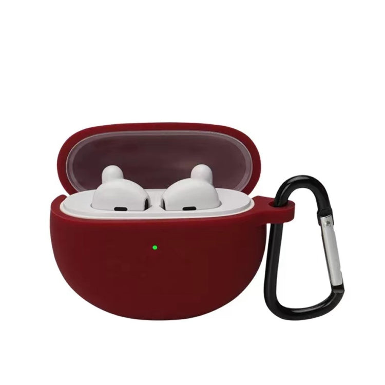 Red wine silicone earbud case with hook, holding two white earbuds in a lid-open shell