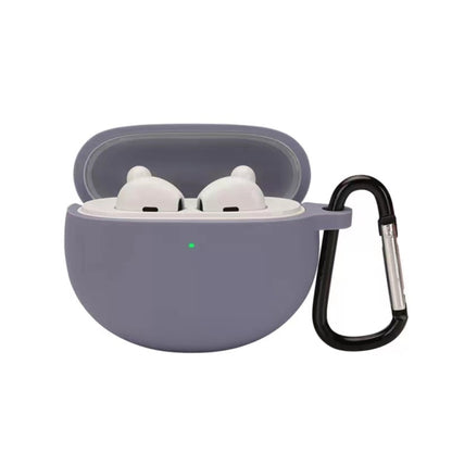 Lavender silicone earbud case with hook, holding two white earbuds in a lid-open shell