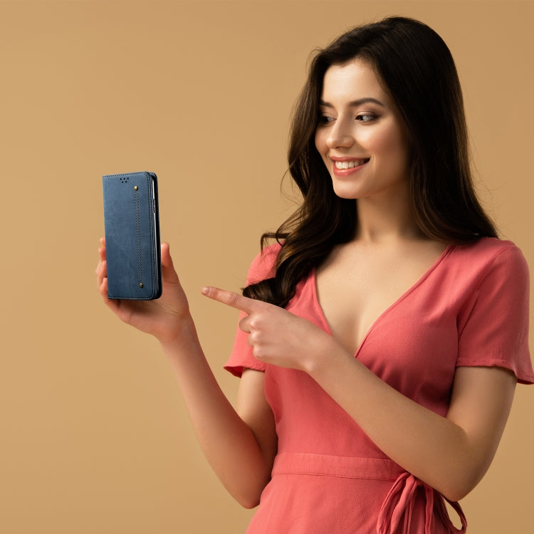 Blue flip leather phone wallet case held in hand, showing front snap closure