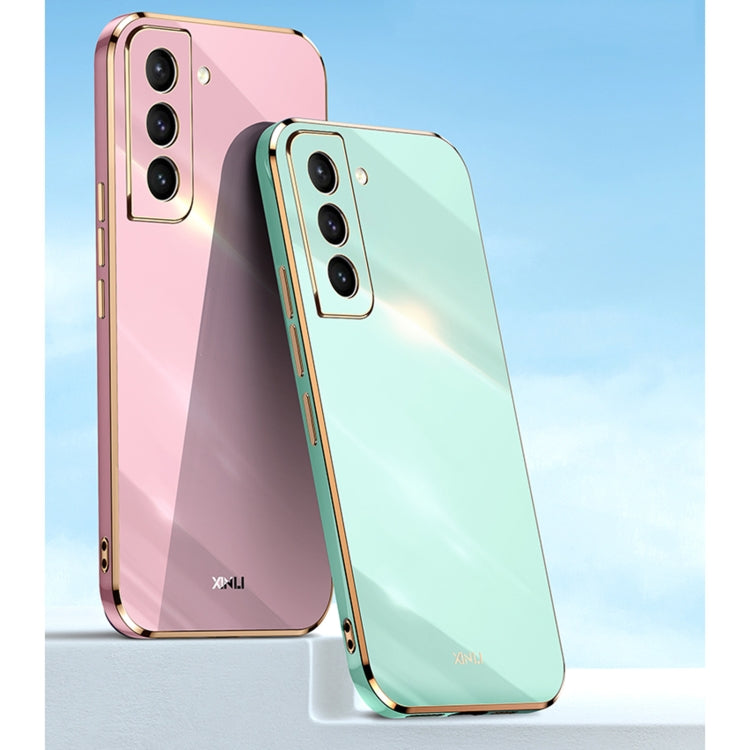 Electroplate TPU phone case pair in pink and mint blue with gold trim and camera cutouts