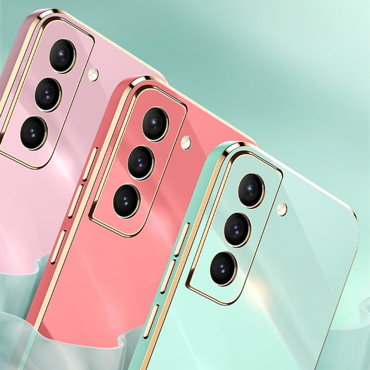 Electroplate TPU phone case pair in pink and mint green with gold trim and triple camera cutouts