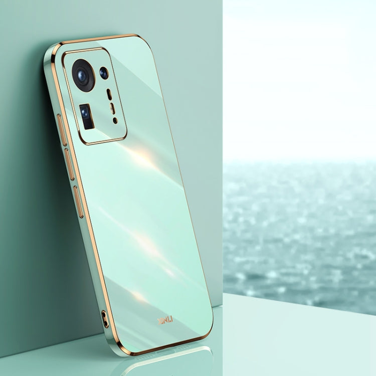 Mint green electroplated TPU phone case with gold trim, raised camera cutouts and button covers