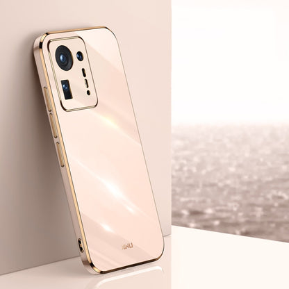 Pink electroplated TPU phone case with gold trim, square camera module cutouts and side ports