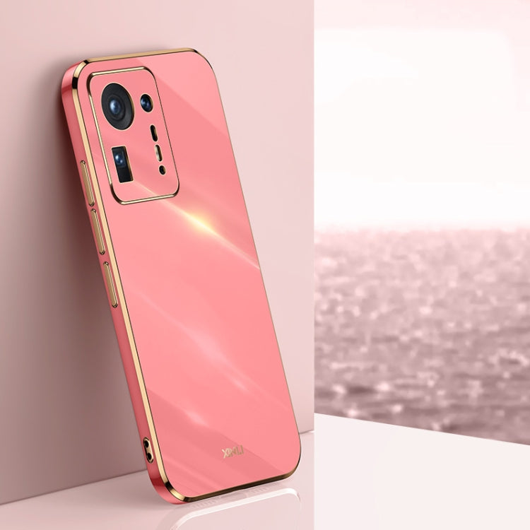 Coral pink electroplated TPU phone case with gold trim, raised camera cutouts and button covers