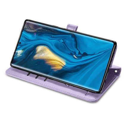 Purple embossed flip leather phone case with clasp tab, shown propped open