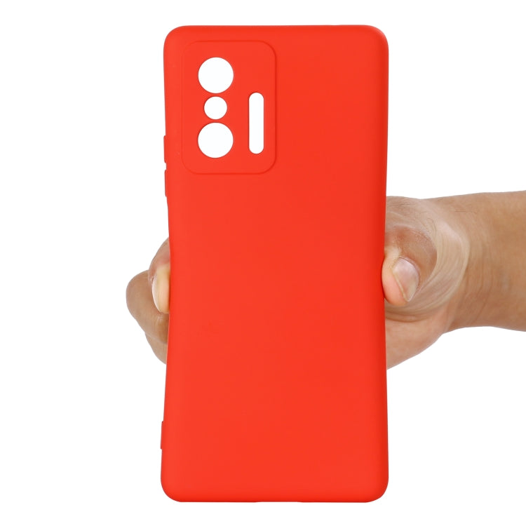 Red liquid silicone full-coverage phone case held in hand with camera cutouts