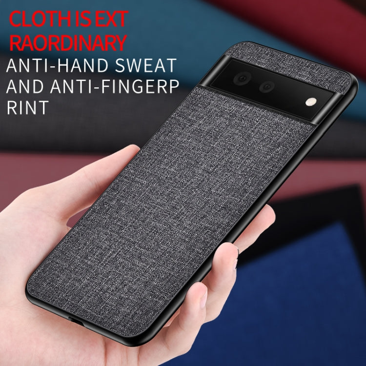 Gray textured phone case held in hand, showing camera cutouts and raised corners