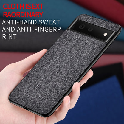 Gray textured phone case held in hand, showing camera cutouts and raised corners