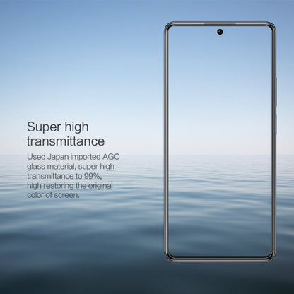 Transparent screen protector film laid over a smartphone display, rounded edges