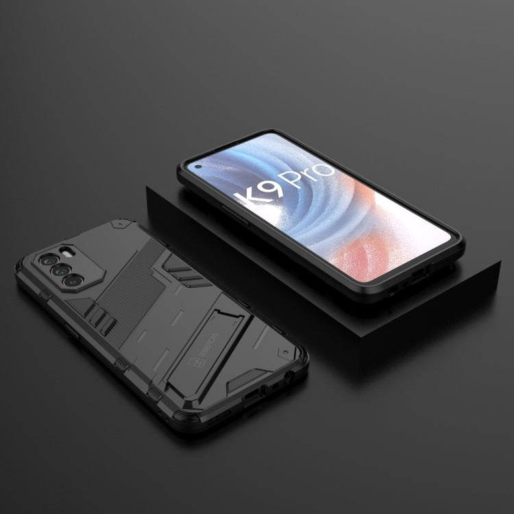 Black rugged phone case with built-in holder, protective corners, and camera cutouts