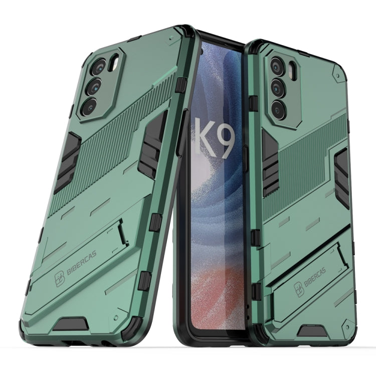 Rugged green phone case with textured grip, raised edges, and dual-layer protection