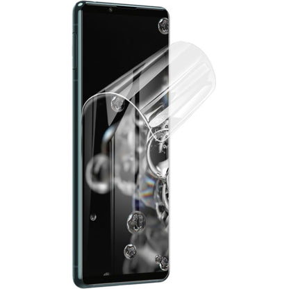 Curved transparent hydrogel screen protector film covering a phone display