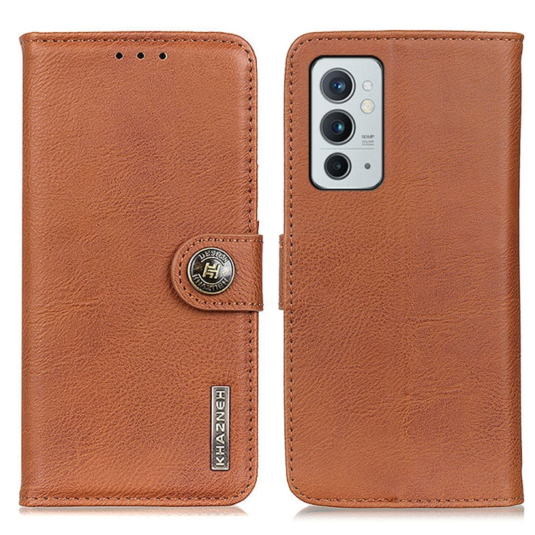 Brown cowhide-texture flip phone case with camera-cutout and circular KHAZNEH snap