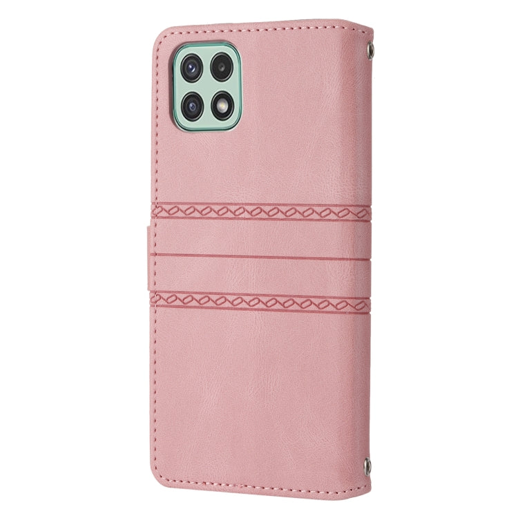 Pink leather flip phone case with embossed striped bands and stitched edges