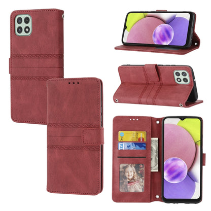 Maroon leather flip phone case with embossed stripes, magnetic buckle, and card slots