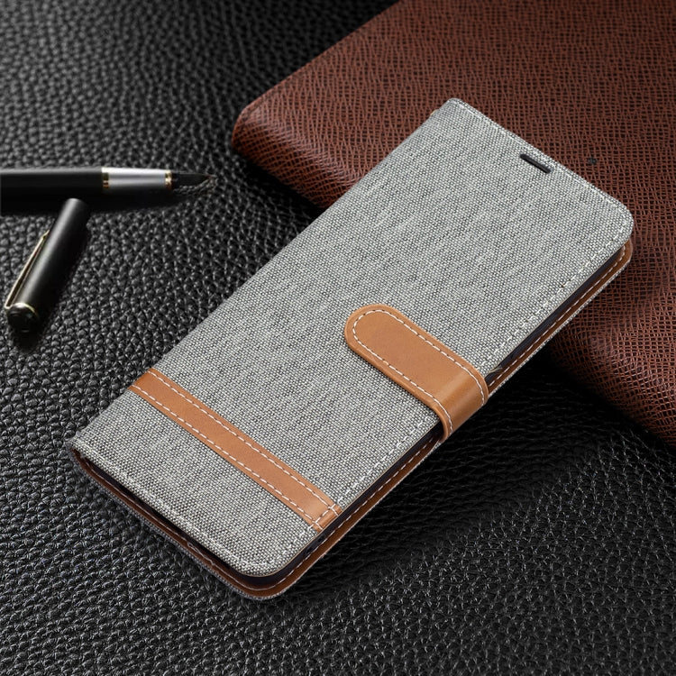 Grey denim-texture phone wallet case with leather trim and magnetic closure strap