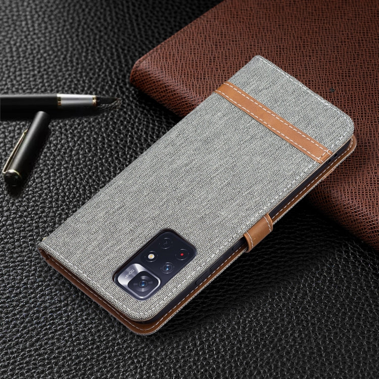 Grey denim-texture phone wallet case with camera cutouts and leather trim