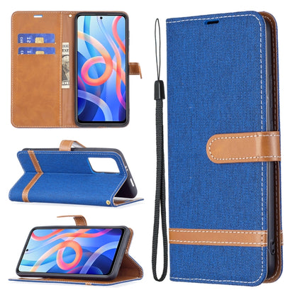 Denim-texture phone wallet case with royal blue fabric, tan trim, card slots, and lanyard