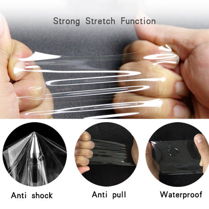 Stretchable hydrogel screen protector film being pulled flat for installation