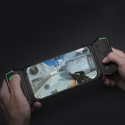 Hands holding a phone with a shockproof case and a snap-on cooling accessory