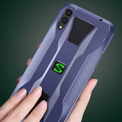 Blue phone case with textured armor panels, camera cutouts, and green logo accents