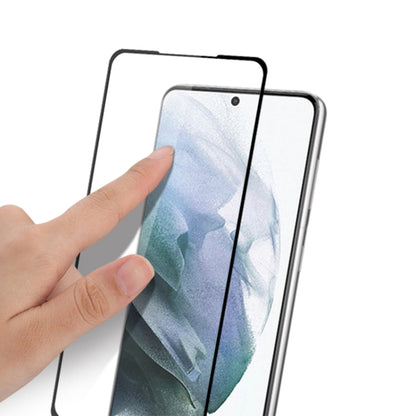 mocolo tempered glass screen protector being applied by hand onto a phone front