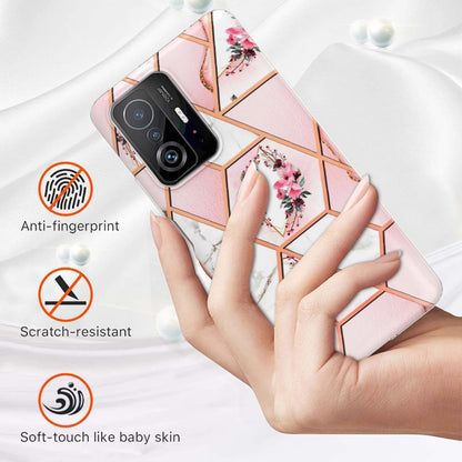 Pink floral hexagon TPU phone case held in hands; soft-touch TPU with clear frame