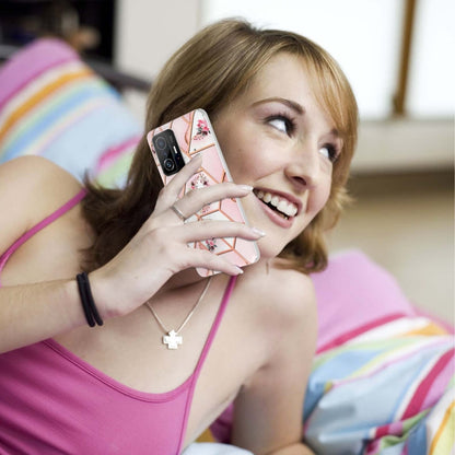 Pink floral TPU phone case on a phone being held; soft-touch clear edge