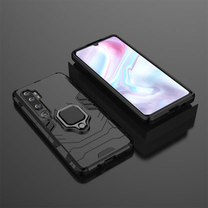 Shockproof black phone case with magnetic ring holder, close-up of textured armor