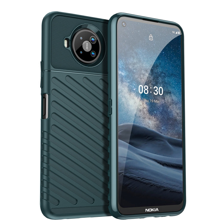 Rugged TPU phone case in dark teal with textured grip and camera cutout, raised edges