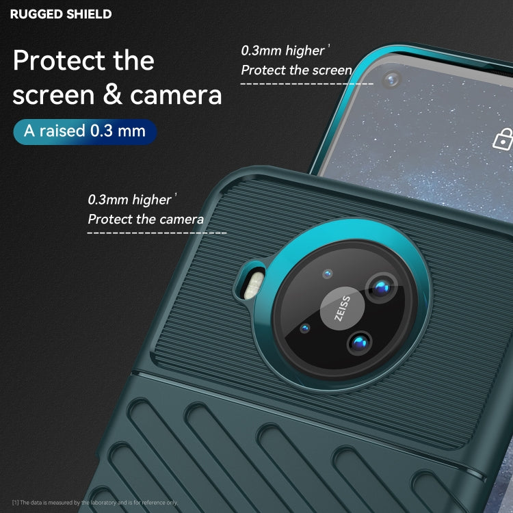 Dark teal TPU case close-up showing raised camera and screen edge protection