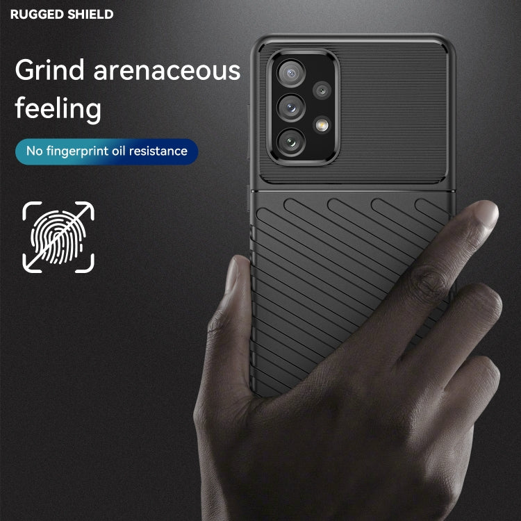 Black rugged TPU phone case with textured back and camera cutouts, hand-grip view