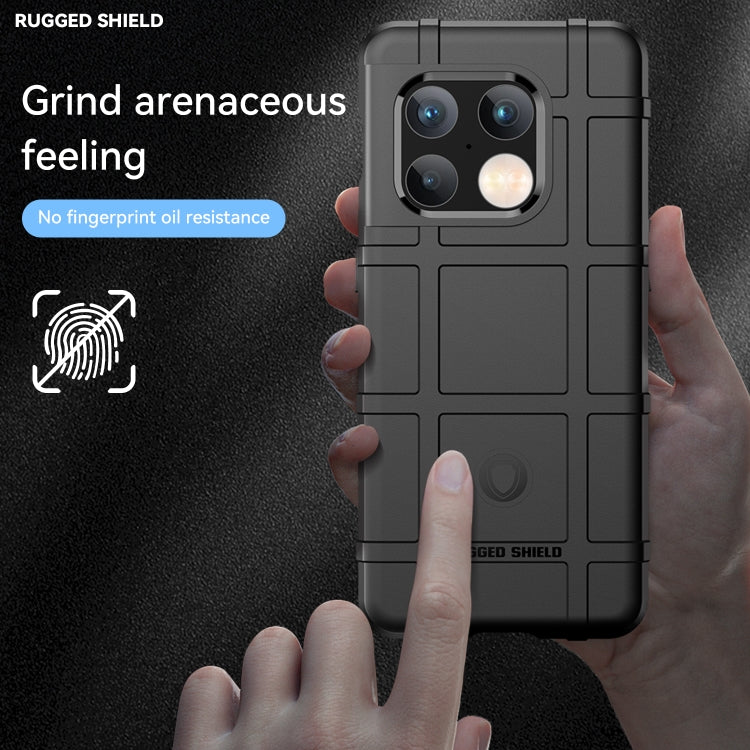 Black rugged TPU phone case held in hand, showing camera cutouts and textured back