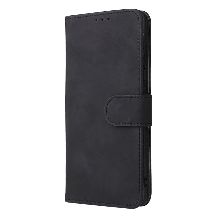 Black leather phone case with side buckle strap and circular snap closure.