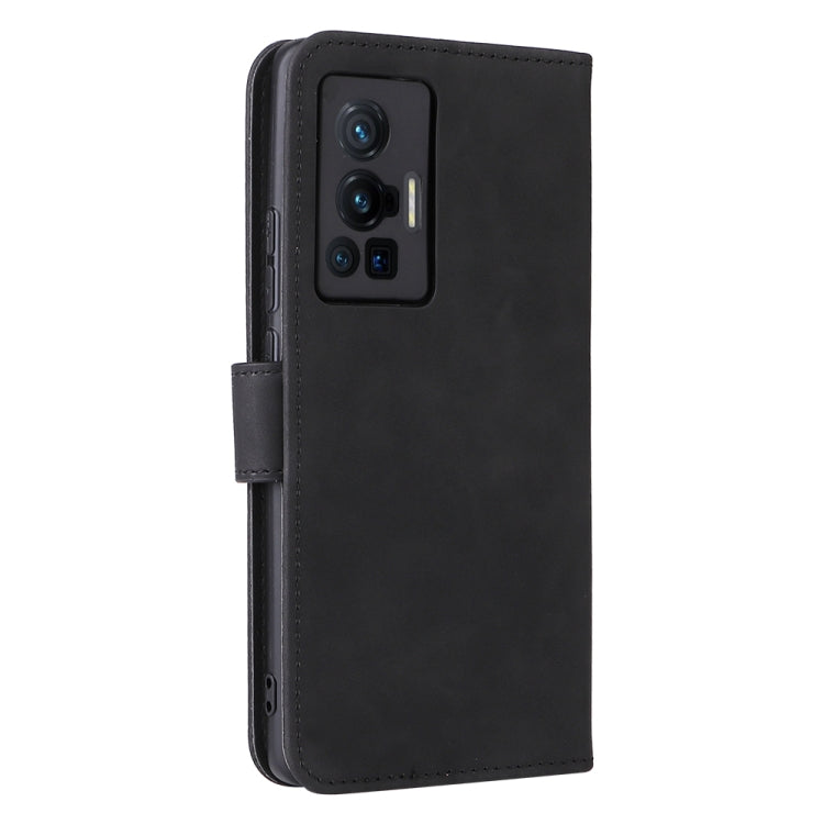 Black leather phone case with stitched flap and openings for camera and ports.